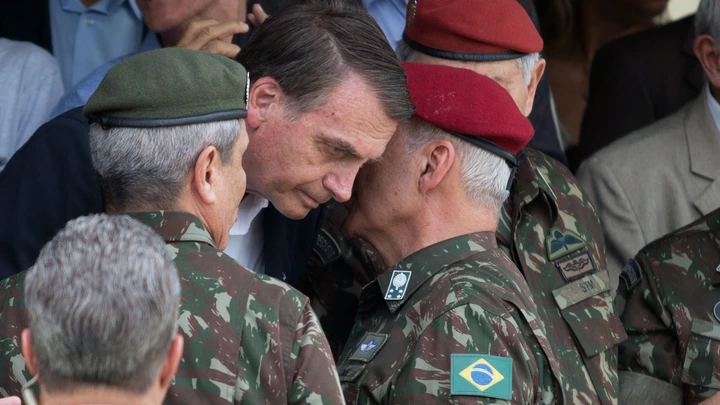 Brazilian Army General Luiz Eduardo Ramos Baptista Pereira (R) speaks to Brazilian President-elect Jair Bolsonaro (C), during the graduation ceremony of new paratroopers at the Parachute Infantry Battalion Vila Militar, in Rio de Janeiro, Brazil, on November 24, 2018. (Photo by Fernando Souza / AFP)        (Photo credit should read FERNANDO SOUZA/AFP via Getty Images) Brazilian Army General Luiz Eduardo Ramos Baptista Pereira (R) speaks to Brazilian President-elect Jair Bolsonaro (C), during the graduation ceremony of new paratroopers at the Parachute Infantry Battalion Vila Militar, in Rio de Janeiro, Brazil, on November 24, 2018. (Photo by Fernando Souza / AFP)        (Photo credit should read FERNANDO SOUZA/AFP via Getty Images)