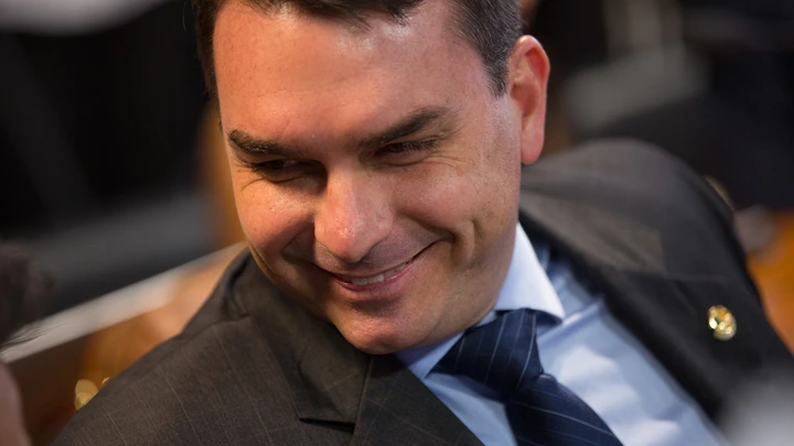 Senator Flavio Bolsonaro, a Social Liberal Party (PSL) member for Rio de Janeiro state, smiles during a confirmation hearing for Roberto Campos Neto, president of the Central Bank of Brazil nominee for Brazilian President Jair Bolsonaro, not pictured, in Brasilia, Brazil, on Tuesday, Feb. 26, 2019. Campos Neto in his initial remarks ticked off several boxes on the investor wish list, such as reaffirming the need for fiscal discipline, inflation control, and central bank autonomy. Photographer: Andre Coelho/Bloomberg via Getty Images