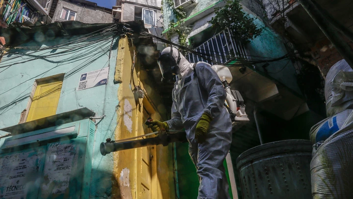 A worker wearing personal protective equipment (PPE) performs disinfection operations at Dona Marta favela in Rio de Janeiro, Brazil, on Saturday, March 27, 2021. Staggering under its worst period of the pandemic, with daily records of caseloads and deaths, Brazil is facing a daunting development: a rising number of deaths among the young. Photographer: Andre Coelho/Bloomberg via Getty Images A worker wearing personal protective equipment (PPE) performs disinfection operations at Dona Marta favela in Rio de Janeiro, Brazil, on Saturday, March 27, 2021. Staggering under its worst period of the pandemic, with daily records of caseloads and deaths, Brazil is facing a daunting development: a rising number of deaths among the young. Photographer: Andre Coelho/Bloomberg via Getty Images