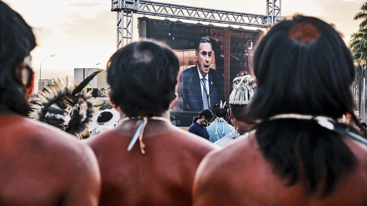A screen shows Supreme Court Justice Luis Roberto Barroso during a protest against a land demarcation judgment outside the Supreme Court building in Brasilia, Brazil, on Wednesday, Aug. 25, 2021. Indigenous protesters have gathered in Brasilia this week to protest a Supreme Court judgment on Wednesday that could take away ancestral lands. Photographer: Gustavo Minas/Bloomberg via Getty Images A screen shows Supreme Court Justice Luis Roberto Barroso during a protest against a land demarcation judgment outside the Supreme Court building in Brasilia, Brazil, on Wednesday, Aug. 25, 2021. Indigenous protesters have gathered in Brasilia this week to protest a Supreme Court judgment on Wednesday that could take away ancestral lands. Photographer: Gustavo Minas/Bloomberg via Getty Images