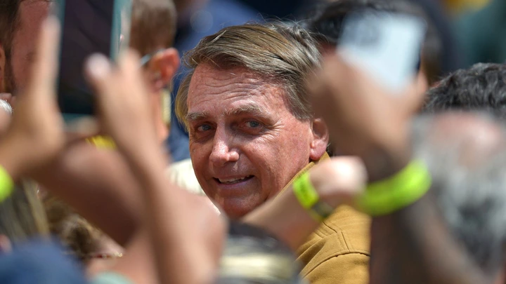 President of Brazil and presidential candidate Jair Bolsonaro greets supporters during a rally to close the penultimate week of campaign ahead of October 02 elections at Praca do Santuario on September 23, 2022 in Divinopolis, Brazil. On Friday 26, Bolsonaro leads rallies in two cities of Minas Gerais, a key district to counteract Lula's votes.