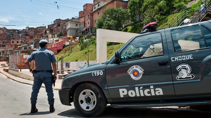 Military police officers patrol Paraisopolis shantytown in Sao Paulo, Brazil, on October 29, 2012. Some 500 officers participated in an operation to prevent crimes such as robbery, seizure of weapons and trafficking or use drugs.  AFP PHOTO / Nelson ALMEIDA        (Photo credit should read NELSON ALMEIDA/AFP/Getty Images)