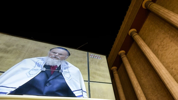 Billionaire Edir Macedo, owner and chairman of Rede Record de Televisao Angola Lda, is projected on a screen displayed outside a replica of Solomon's Temple during its inauguration ceremony in Sao Paulo, Brazil, on Thursday, July 31, 2014. Billionaire Edir Macedo's temple spans two city blocks and cost 680 million reais ($300 million) to erect. Macedo's net worth has grown to $1.5 billion since he bought the Record TV network in 1989 with a $45 million interest-free loan from the Universal Church of the Kingdom of God, which he founded, according to the Bloomberg Billionaires Index. Photographer: Paulo Fridman/Bloomberg via Getty Images