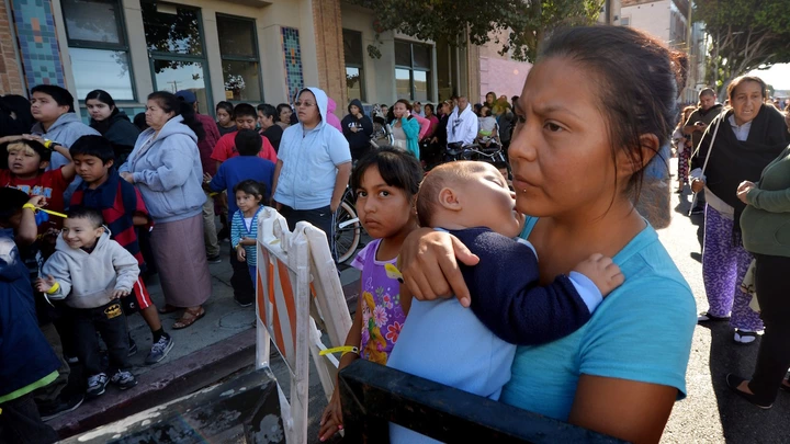 Mothers and their children wait for new shoes and school supplies during a charity event to help more than 4,000 underprivileged children at the Fred Jordan Mission in the Skid Row area of Los Angeles on October 2, 2014. Skid Row reportedly contains one of the largest populations of homeless people in the United States.                  AFP PHOTO/Mark RALSTON        (Photo credit should read MARK RALSTON/AFP/Getty Images) Mothers and their children wait for new shoes and school supplies during a charity event to help more than 4,000 underprivileged children at the Fred Jordan Mission in the Skid Row area of Los Angeles on October 2, 2014. Skid Row reportedly contains one of the largest populations of homeless people in the United States.                  AFP PHOTO/Mark RALSTON        (Photo credit should read MARK RALSTON/AFP/Getty Images)