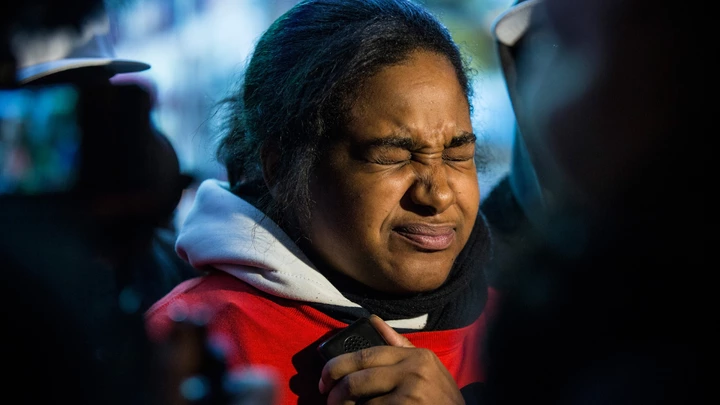 NEW YORK, NY - DECEMBER 11:  Erica Garner, daughter of Eric Garner, holds back tears while speaking to the media after leading a march of people protesting the Staten Island, New York grand jury's decision not to indict a police officer involved in the chokehold death of Eric Garner in July, on December 11, 2014 in the Staten Island Neighborhood of New York City. Protests have continued throughout the country since the Grand Jury's decision was announced last week.  (Photo by Andrew Burton/Getty Images) NEW YORK, NY - DECEMBER 11:  Erica Garner, daughter of Eric Garner, holds back tears while speaking to the media after leading a march of people protesting the Staten Island, New York grand jury's decision not to indict a police officer involved in the chokehold death of Eric Garner in July, on December 11, 2014 in the Staten Island Neighborhood of New York City. Protests have continued throughout the country since the Grand Jury's decision was announced last week.  (Photo by Andrew Burton/Getty Images)