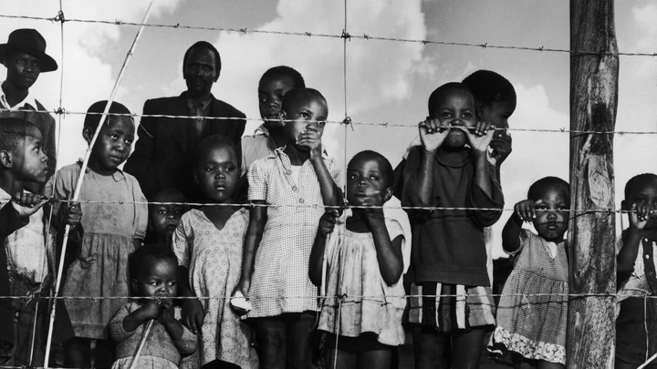 A group of children (and a few men) gaze from behind a barbed-wire fence that marks the boundary of the Moroka township in Soweta, Johannesburg, South Africa, April 21, 1950. (Photo by Margaret Bourke-White/The LIFE Picture Collection via Getty Images) A group of children (and a few men) gaze from behind a barbed-wire fence that marks the boundary of the Moroka township in Soweta, Johannesburg, South Africa, April 21, 1950. (Photo by Margaret Bourke-White/The LIFE Picture Collection via Getty Images)