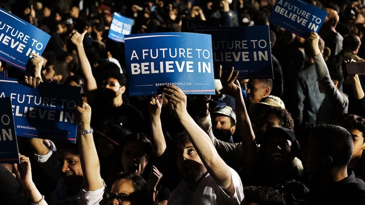 NEW YORK, NY - APRIL 18:  People cheer as Democratic Presidential candidate Bernie Sanders walks on stage at a campaign rally on the eve of the New York primary, April 18, 2016 in the Queens borough of New York City. While Sanders is still behind in the delegate count with Hillary Clinton, he has energized many young and liberal voters around the country. New York holds its primary this Tuesday.  (Photo by Spencer Platt/Getty Images)