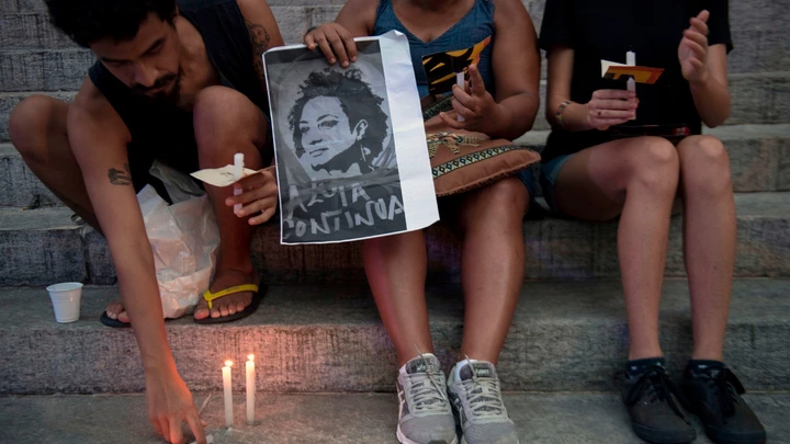 People light candles during a demonstration against the murder of councilwoman and activist Marielle Franco, in front of Rio de Janeiro's Legislative House on March 16, 2018. Brazilians mourned for second consecutive day a Rio de Janeiro councilwoman, black rights activist and outspoken critic of police brutality who was shot in an assassination-style killing on March 14. / AFP PHOTO / Mauro Pimentel (Photo credit should read MAURO PIMENTEL/AFP/Getty Images)