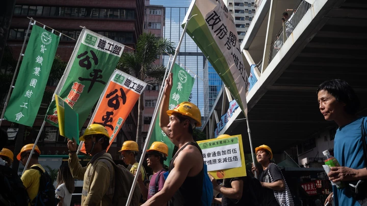 Protestantes participam de manifestação do Dia do Trabalho em Hong Kong, em primeiro de maio de 2018. Protestantes participam de manifestação do Dia do Trabalho em Hong Kong, em primeiro de maio de 2018.
