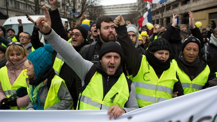 “Coletes amarelos” cantam palavras de ordem enquanto marcham por Paris, em 12 de janeiro de 2019.