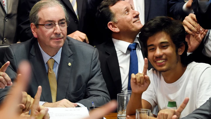 Kim Kataguiri (R), leader of the Free Brazil Movement (MBL), meets with Brazilian Lower House President Eduardo Cunha in Brasilia, Brazil on May 27, 2015. Kataguiri, a 19-year-old college drop out, is the face of MBL, a growing force which seeks to harness some of the energy of the 2013 protest movement which brought more than a million onto the streets. AFP PHOTO/EVARISTO SA        (Photo credit should read EVARISTO SA/AFP/Getty Images) Kim Kataguiri (R), leader of the Free Brazil Movement (MBL), meets with Brazilian Lower House President Eduardo Cunha in Brasilia, Brazil on May 27, 2015. Kataguiri, a 19-year-old college drop out, is the face of MBL, a growing force which seeks to harness some of the energy of the 2013 protest movement which brought more than a million onto the streets. AFP PHOTO/EVARISTO SA        (Photo credit should read EVARISTO SA/AFP/Getty Images)
