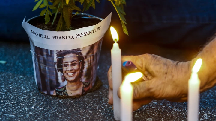 An elderly man lights a candle during a rally against the murder of Brazilian councilwoman and activist Marielle Franco, in Sao Paulo Brazil on March 15, 2018.Brazilians mourned for the Rio de Janeiro councilwoman and outspoken critic of police brutality who was shot in the city center in an assassination-style killing on the eve. / AFP PHOTO / Miguel SCHINCARIOL (Photo credit should read MIGUEL SCHINCARIOL/AFP/Getty Images)