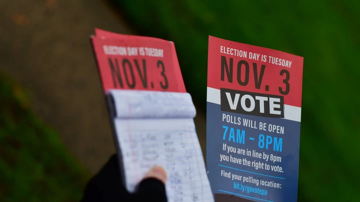 Caleb Malchik, 27, segura panfletos que informam o dia da votação, em campanha do sindicato Unite Here para Joe Biden, em 1º de novembro de 2020, em Landsdowne, Pensilvânia. 