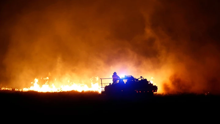 Firefighters from across Kansas and Oklahoma battle a wildfire near Protection, Kan., Monday, March 6, 2017. (Bo Rader/The Wichita Eagle via AP) Firefighters from across Kansas and Oklahoma battle a wildfire near Protection, Kan., Monday, March 6, 2017. (Bo Rader/The Wichita Eagle via AP)