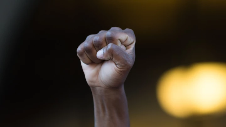 Los Angeles, USA - July 12, 2016 -  Black lives matter protestor put their fists in the air as a sign of 'black power' on City Hall following ruling on LAPD fatal shooting of African American female Redel Jones Los Angeles, USA - July 12, 2016 -  Black lives matter protestor put their fists in the air as a sign of 'black power' on City Hall following ruling on LAPD fatal shooting of African American female Redel Jones