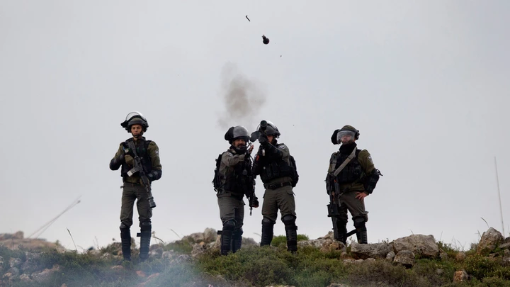 Israeli troops fire teargas at protesters during a clashes following a protest to mark the Land Day, in the village of Qusra, near the West Bank City of Nablus, Friday, March 30, 2018. (AP Photo/Majdi Mohammed)