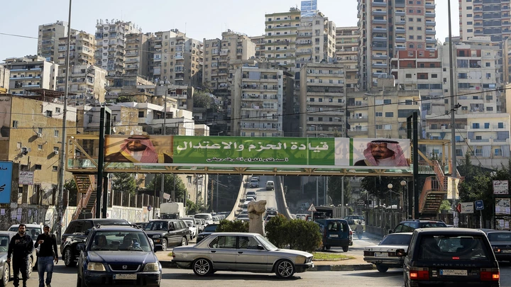 A picture taken on November 10, 2017 shows a banner bearing the images of Saudi King Salman bin Abdulaziz (R) and Crown Prince Mohammed bin Salman (L) hanging on a pedestrian crossing bridge in the northern Lebanese port city of Tripoli, between them a caption reading in Arabic "firm and moderating leadership", days after Lebanese Prime Minister Saad Hariri announced his resignation during a televised speech airing from the Saudi capital Riyadh.Hariri's announced resignation sparked concerns of a political crisis in Lebanon as tensions between Saudi Arabia and Iran escalated. / AFP PHOTO / JOSEPH EID (Photo credit should read JOSEPH EID/AFP/Getty Images) A picture taken on November 10, 2017 shows a banner bearing the images of Saudi King Salman bin Abdulaziz (R) and Crown Prince Mohammed bin Salman (L) hanging on a pedestrian crossing bridge in the northern Lebanese port city of Tripoli, between them a caption reading in Arabic "firm and moderating leadership", days after Lebanese Prime Minister Saad Hariri announced his resignation during a televised speech airing from the Saudi capital Riyadh.Hariri's announced resignation sparked concerns of a political crisis in Lebanon as tensions between Saudi Arabia and Iran escalated. / AFP PHOTO / JOSEPH EID (Photo credit should read JOSEPH EID/AFP/Getty Images)