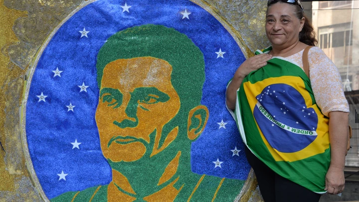 A woman stands next to an image of Brazilian judge Sergio Moro during a protest against suspended president Dilma Rousseff in Sao Paulo, on July 31, 2016.Protesters took to the streets of Brazil on Sunday to demand the final leaving of suspended President Dilma Rousseff or to defend her continuance, just five days before the start of the Rio 2016 Olympic Games. / AFP / NELSON ALMEIDA (Photo credit should read NELSON ALMEIDA/AFP/Getty Images)