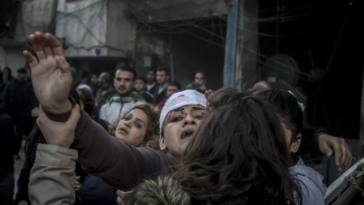 2757513 12/12/2015 Residents and relatives of the victims on the site of the terrorist act in downtown Homs. On December 12, terrorists staged a deadly car bomb attack near the Al-Ahli hospital. Valeriy Melnikov/Sputnik via AP