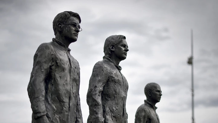 A picture of the installation "Anything to Say?", a bronze sculpture and art installation by Italian sculptor Davide Dormino representing whistleblowers (from L) Edward Snowden, Julian Assange and Chelsea Manning is seen on the Place des Nations next to the United Nations Offices in Geneva, on September 15, 2015.  AFP PHOTO / FABRICE COFFRINI-- RESTRICTED TO EDITORIAL USE, MANDATORY MENTION OF THE ARTIST UPON PUBLICATION, TO ILLUSTRATE THE EVENT AS SPECIFIED IN THE CAPTION --        (Photo credit should read FABRICE COFFRINI/AFP/Getty Images)