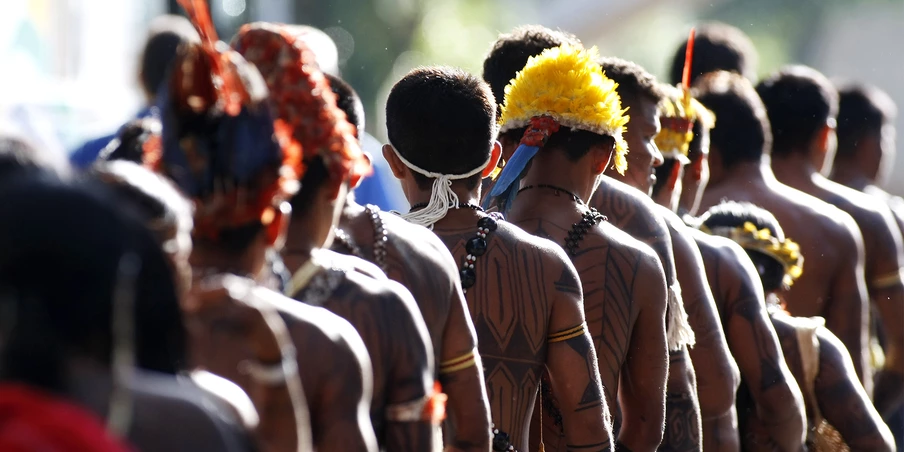 Mundurukus natives opposed to the construction of the controversial Belo Monte dam in the state of Para arrive at the Planalto Palace in Brasilia on June 4, 2013 to hold a meeting with Brazil's Secretary General of the Presidency, Gilberto Carvalho. Five indigenous tribes are calling for legislation under which they would have to be consulted prior to any official decision affecting them with respect to the dam's construction. Belo Monte, which is being built at a cost of $13 billion, is expected to flood an area of 500 square km along the Xingu River, displacing 16,000 people, according to the government. Some NGOs have estimated that some 40,000 people would be displaced by the massive project. Indigenous groups say the dam will harm their way of life while environmentalists warn of deforestation, greenhouse gas emissions and irreparable damage to the ecosystem.  AFP PHOTO/Beto BARATA        (Photo credit should read BETO BARATA/AFP/Getty Images)