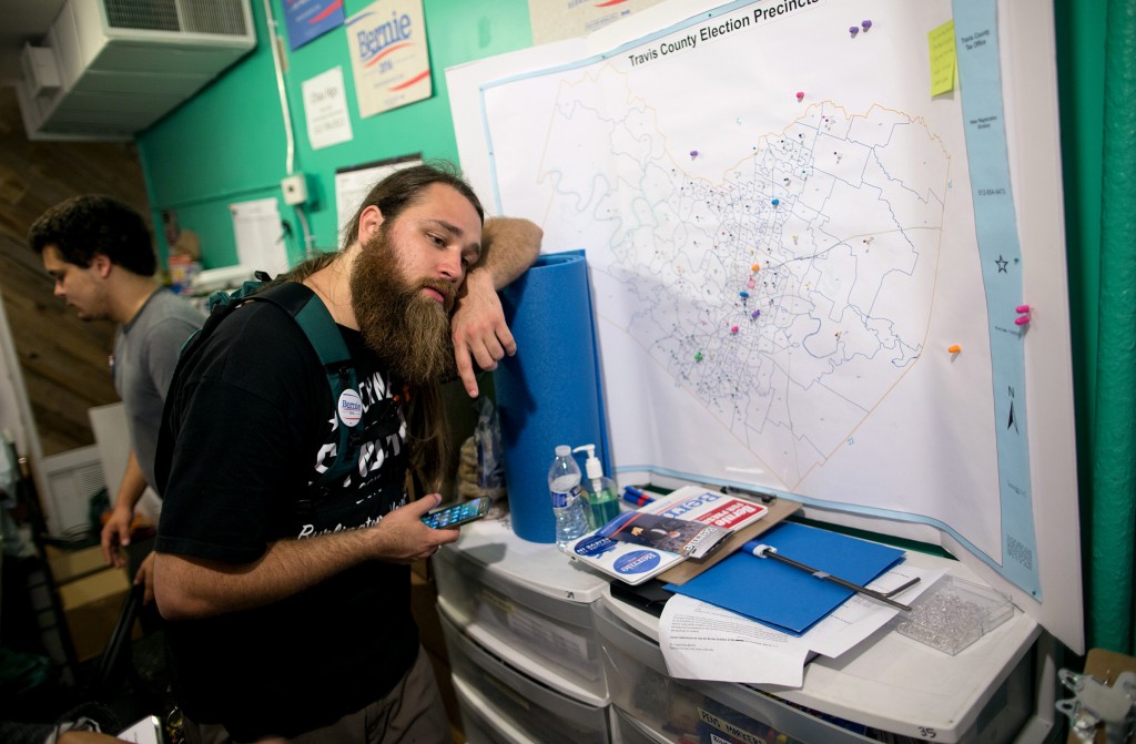 Matt Krausse, a Bernie Sanders campaign volunteer, strategizes where to distribute brochures reminding Sanders supporters to vote in the Super Tuesday primaries, at the campaign headquarters in Austin, Texas early Tuesday morning, March 1, 2016. The local Sanders campaign mobilized over 40 volunteers in a grassroots effort to canvas Austin neighborhoods before dawn. (AP Photo/Tamir Kalifa)
